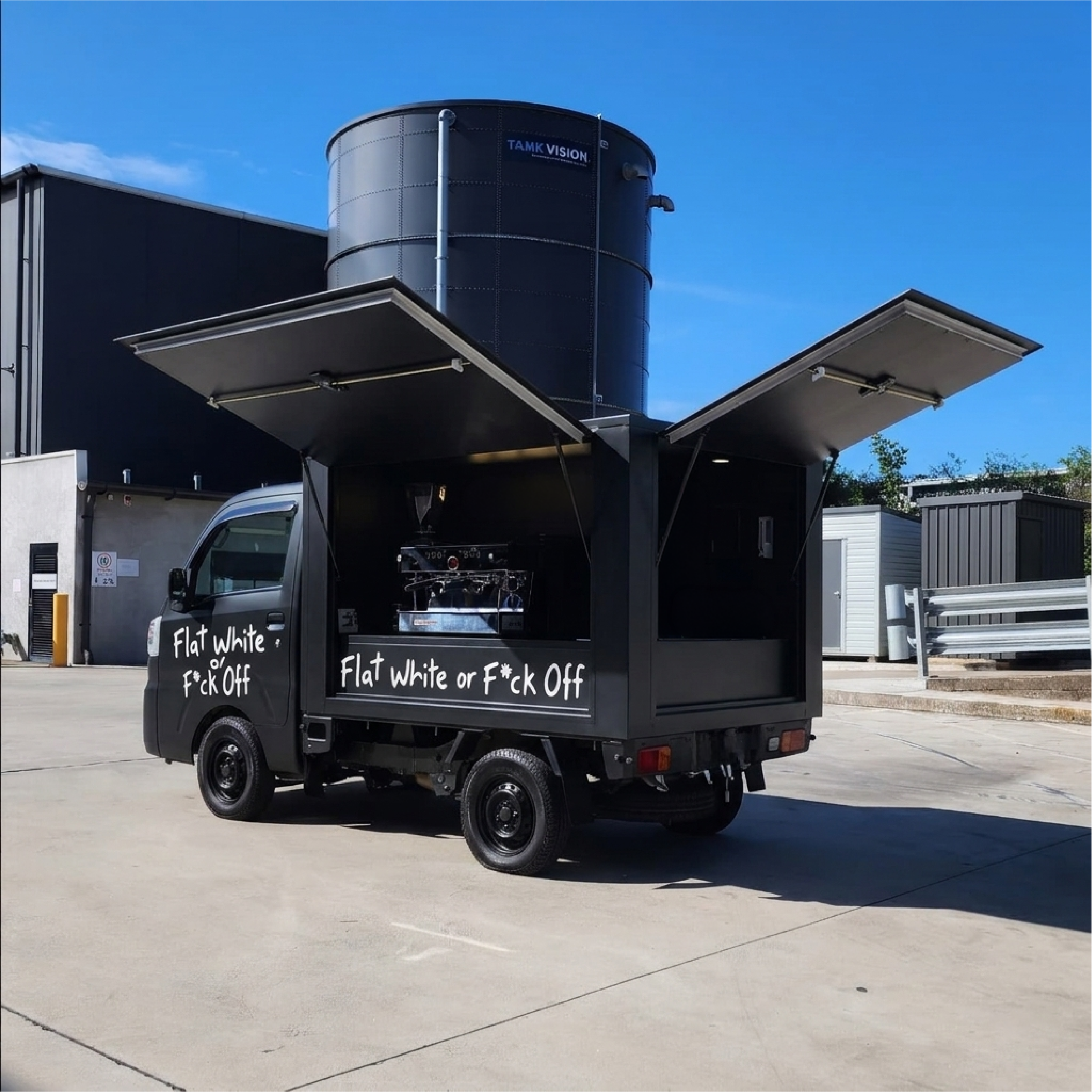 The coffee van from the rear with both hatches open